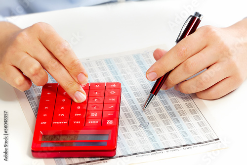 Photo: Hand with calculator. Hand with calculator.