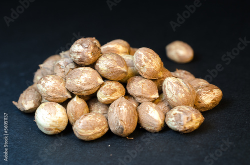 Photo: Handful of whole hazel nuts isolated on black Handful of whole hazel nuts isolated on black