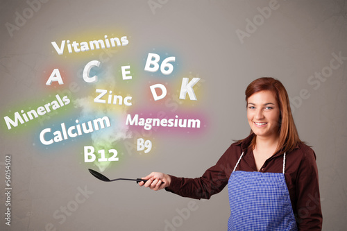 Photo: Young woman cooking vitamins and minerals Young woman cooking vitamins and minerals