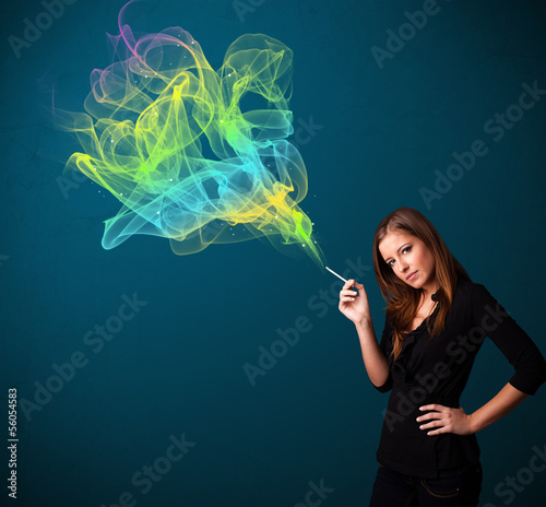 Photo: Pretty lady smoking cigarette with colorful smoke Pretty lady smoking cigarette with colorful smoke