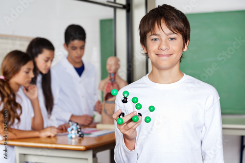 Photo: Teenage Schoolboy Holding Molecular Structure In Biology Class Teenage Schoolboy Holding Molecular Structure In Biology Class