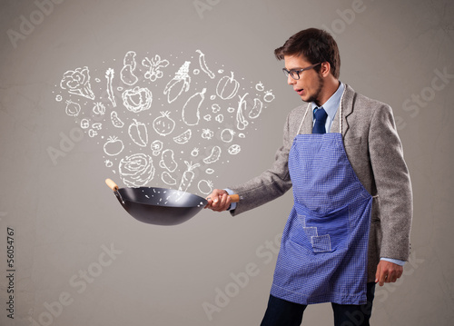 Photo: Attractive man cooking vegetables Attractive man cooking vegetables