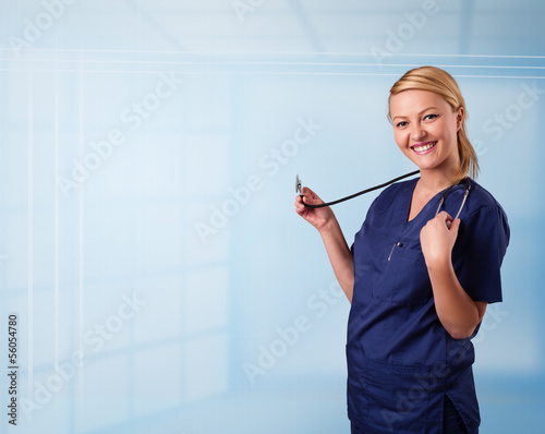 Photo: Pretty nurse in hospital listening to empty copy space with sthe Pretty nurse in hospital listening to empty copy space with sthe