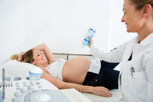Photo: Doctor Applying Gel On Pregnant Woman's Belly Doctor Applying Gel On Pregnant Woman's Belly