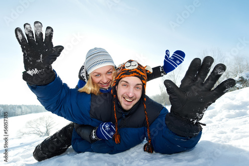 Photo: young happy couple sledding in winter young happy couple sledding in winter