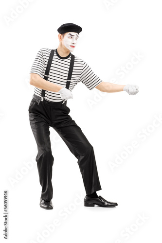 Photo: Male mime artist performing pulling virtual rope Male mime artist performing pulling virtual rope