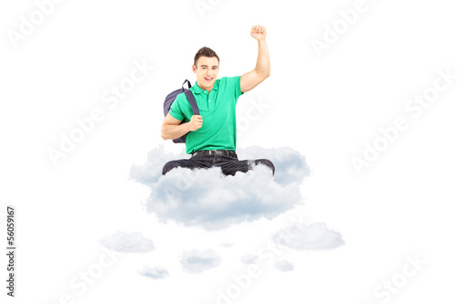 Photo: Happy male student sitting on a cloud with raised hand gesturing Happy male student sitting on a cloud with raised hand gesturing