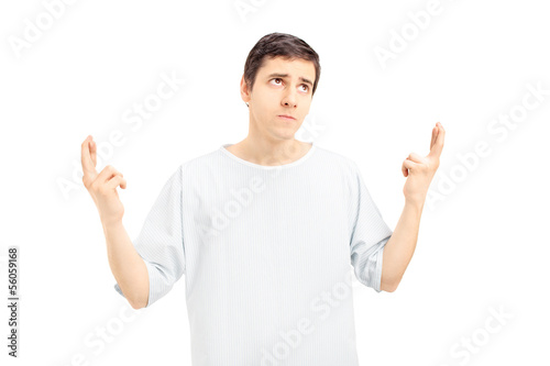Photo: Male patient with fingers crossed looking upwards Male patient with fingers crossed looking upwards