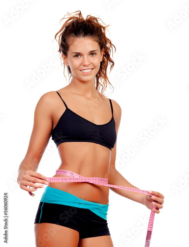Photo: Slim brunette girl with tape measure and fitness clothes Slim brunette girl with tape measure and fitness clothes