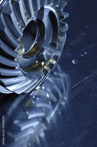 Photo: gears, oil and lubricant mirrored in titanium gears, oil and lubricant mirrored in titanium