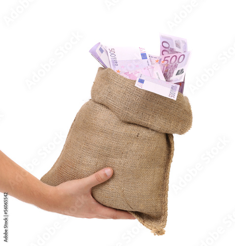 Photo: Hand holding bag with many banknotes Hand holding bag with many banknotes