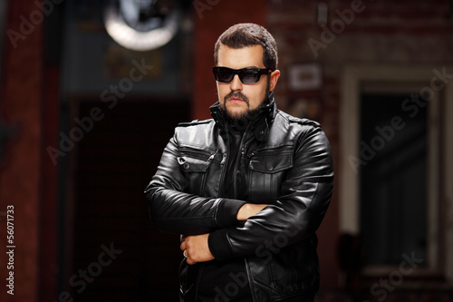 Photo: Man with glasses wearing black jacket and posing Man with glasses wearing black jacket and posing
