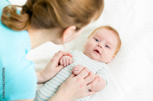 Photo: mom playing with her baby infant mom playing with her baby infant
