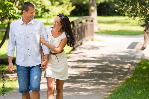Photo: Cheerful Caucasian couple walking outdoors Cheerful Caucasian couple walking outdoors