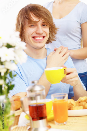 Photo: Young happy man drinking tea Young happy man drinking tea