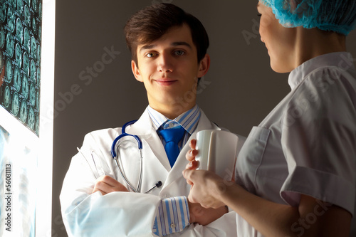 Photo: Two doctors examining x-ray results Two doctors examining x-ray results