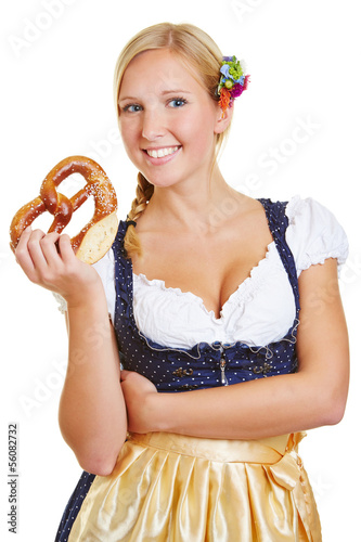 Photo: Woman holding pretzel in dirndl Woman holding pretzel in dirndl