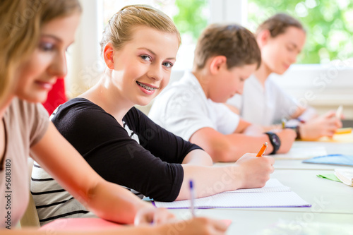 Photo: Students writing a test in school concentrating Students writing a test in school concentrating