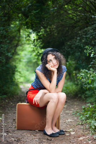 Photo: Young woman thinking about her next destination Young woman thinking about her next destination
