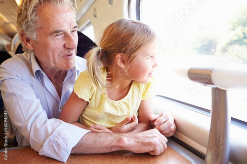 Photo: Grandfather And Granddaughter Relaxing On Train Journey Grandfather And Granddaughter Relaxing On Train Journey