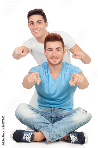 Photo: Couple of best friends pointing to the front Couple of best friends pointing to the front