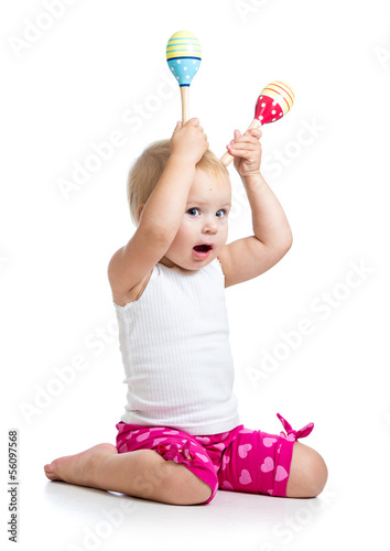 Photo: Kid girl playing with musical toys. Isolated on white background Kid girl playing with musical toys. Isolated on white background