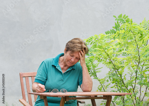 Photo: senior woman with hand on forehead senior woman with hand on forehead