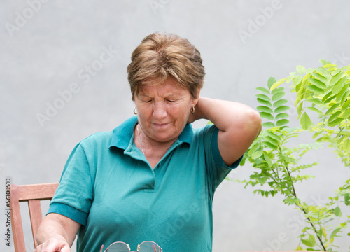 Photo: Older woman has neck pain Older woman has neck pain