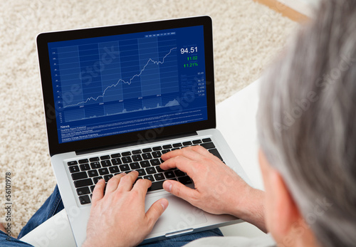 Photo: Mature man using laptop Mature man using laptop