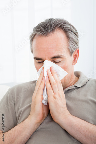 Photo: Man blowing his nose Man blowing his nose