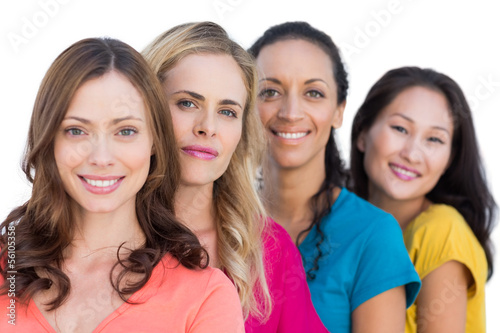 Photo: Smiling models in a line posing with colorful t shirts Smiling models in a line posing with colorful t shirts
