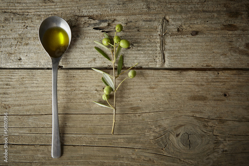 Photo: olive branch and a spoon full of oil olive branch and a spoon full of oil