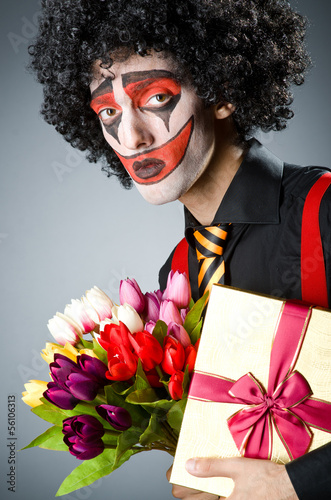 Photo: Sad clown with the flowers Sad clown with the flowers
