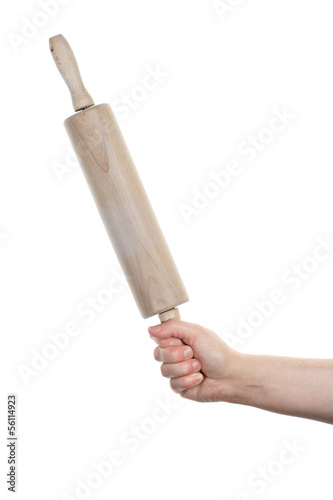 Photo: Female hand with wooden rolling pin Female hand with wooden rolling pin