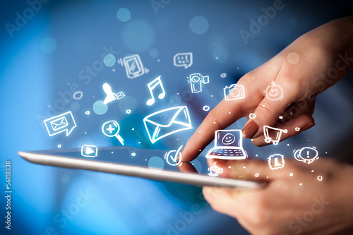 Photo: Finger pointing on tablet pc, social media concept Finger pointing on tablet pc, social media concept
