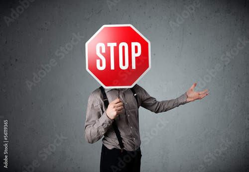 Photo: Businessman holding a stop sign Businessman holding a stop sign