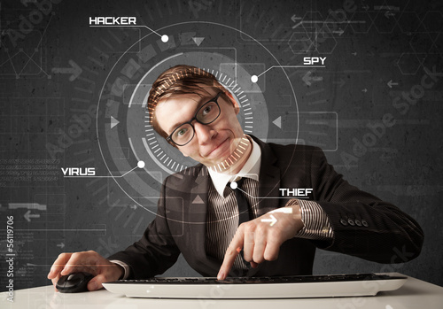 Photo: Young hacker in futuristic enviroment hacking personal informati Young hacker in futuristic enviroment hacking personal informati