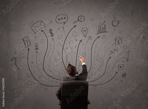 Photo: Businessman in front of a chalkboard deciding with arrows and si Businessman in front of a chalkboard deciding with arrows and si