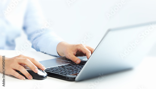 Photo: Hands with laptop computer keyboard. Hands with laptop computer keyboard.