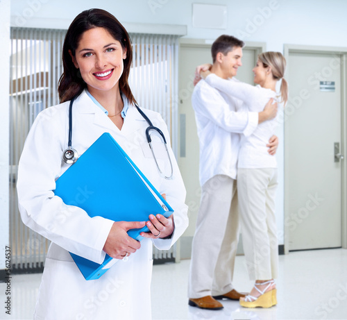 Photo: Smiling medical doctor woman and family. Smiling medical doctor woman and family.