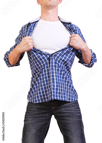 Photo: Superhero. Image of young man tearing his shirt off isolated on Superhero. Image of young man tearing his shirt off isolated on