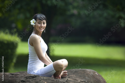 Photo: Young Asian Woman Smiling in Yoga Position Young Asian Woman Smiling in Yoga Position