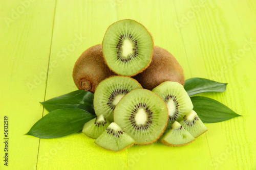 Photo: Ripe kiwi on green wooden table close-up Ripe kiwi on green wooden table close-up