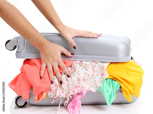 Photo: Suitcase with no neatly folded things isolated on white Suitcase with no neatly folded things isolated on white