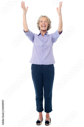 Photo: Excited pretty aged lady, full length shot. Excited pretty aged lady, full length shot.