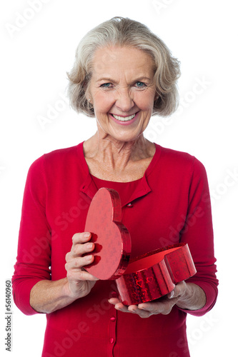 Photo: Senior woman with heart shaped gift box Senior woman with heart shaped gift box