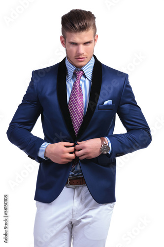Photo: young business man taking suit jacket off young business man taking suit jacket off