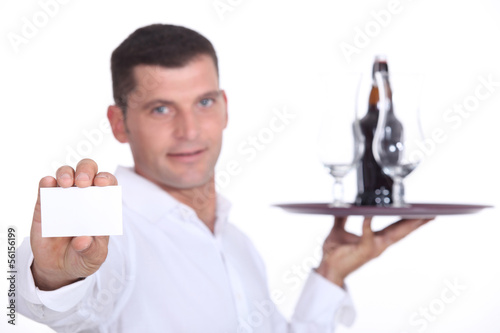 Photo: Waiter holding tray and business card Waiter holding tray and business card