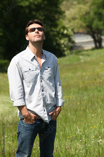 Photo: Man standing in a field Man standing in a field