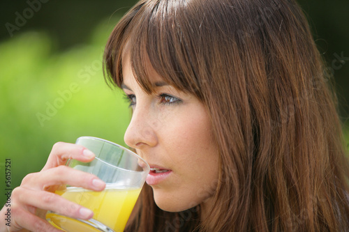 Photo: woman drinking orange juice woman drinking orange juice
